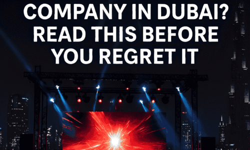 Hiring an event production company in Dubai – stage setup with LED screen and city skyline at night.